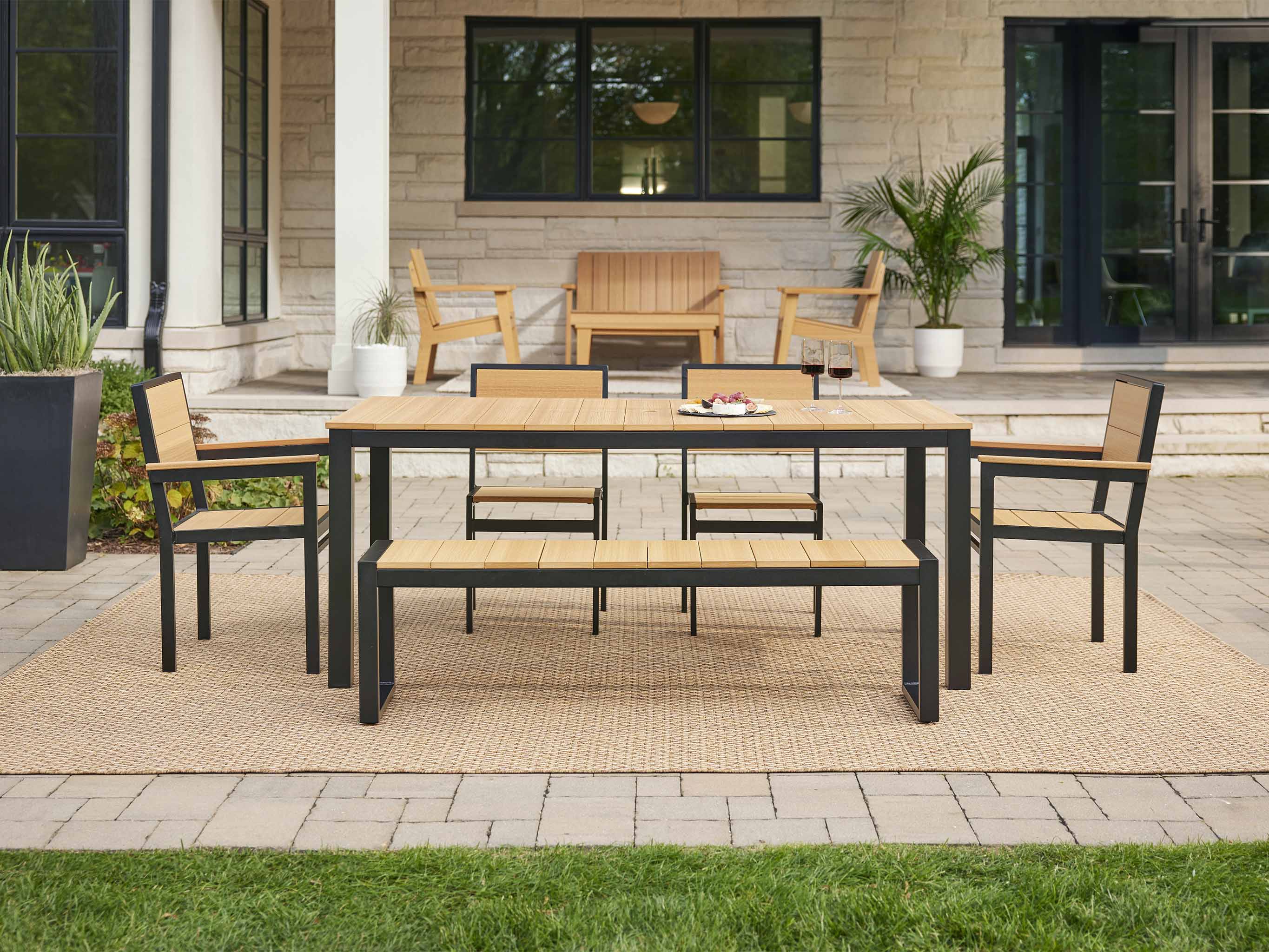 Natural Teak Park City Dining Set on a Brick Patio