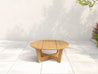 Natural Teak Cannon Beach Conversation Table on white stone patio