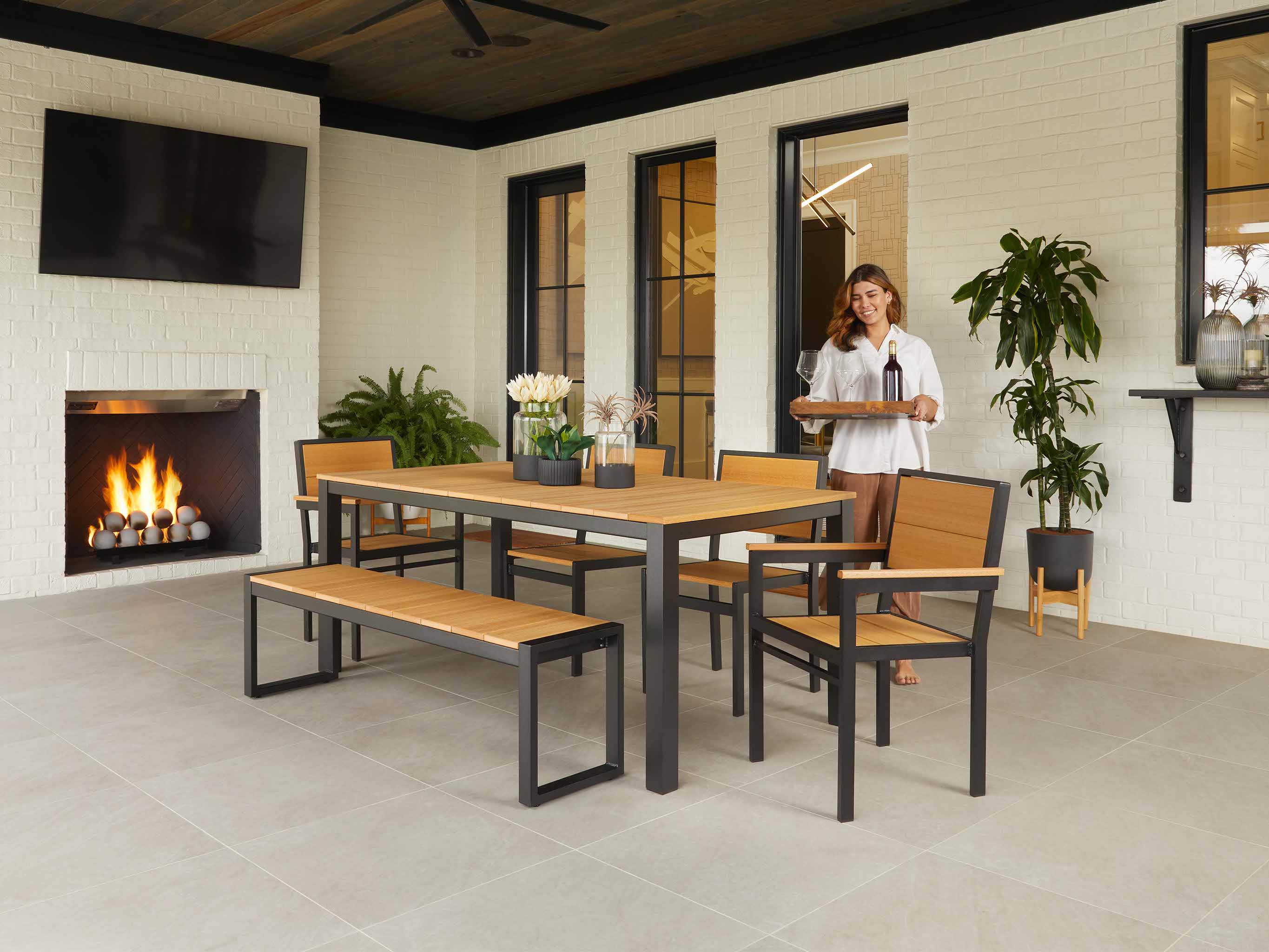 Park City Farmhouse Dining Set with woman carrying wine tray