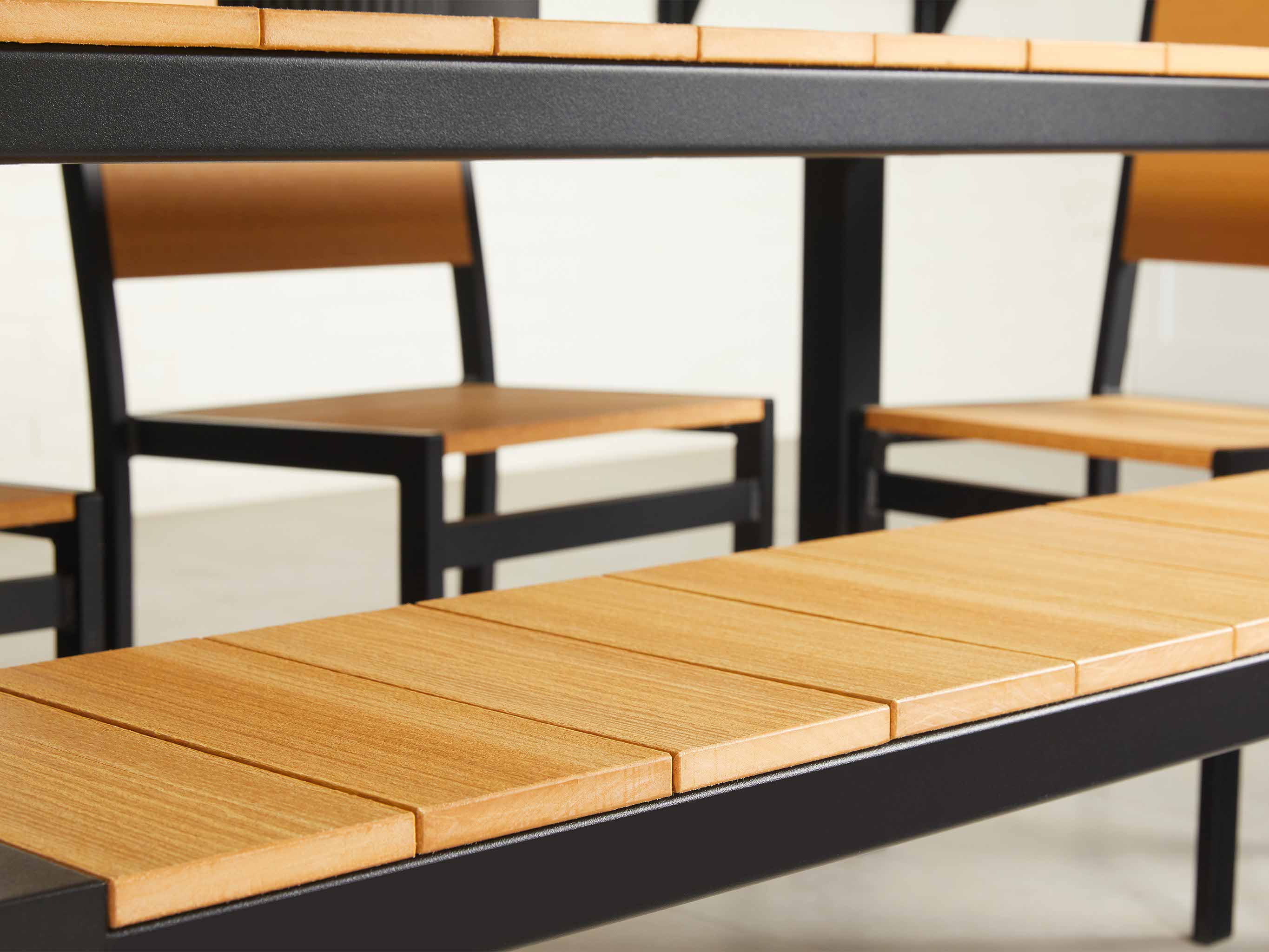 Park City Dining Set with Natural Teak woodgrain and black frame Closeup
