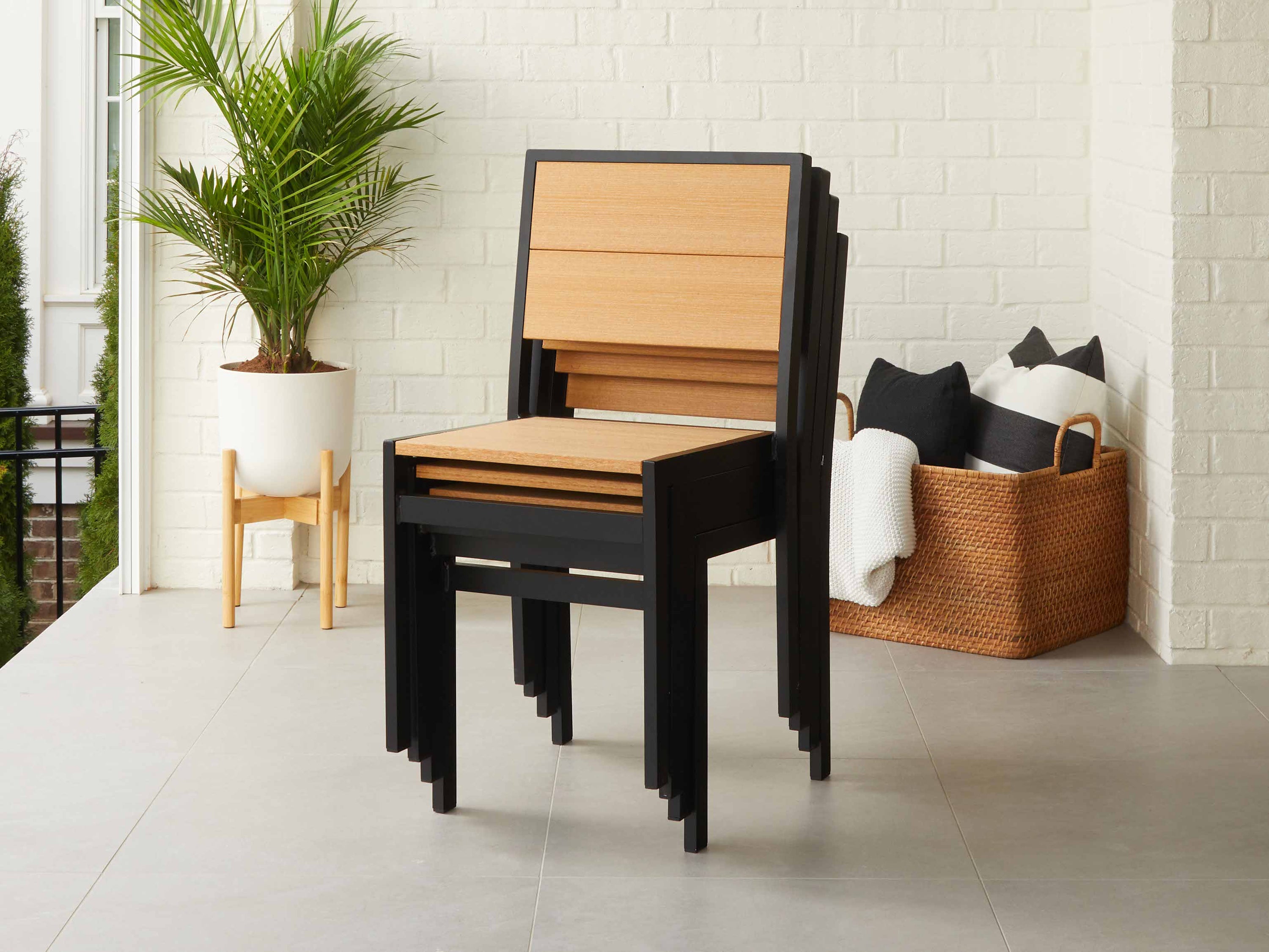 Stack of Park City Chairs Natural Teak with Black Frame on Porch