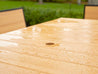 Water droplets on Natural Teak table with umbrella hole