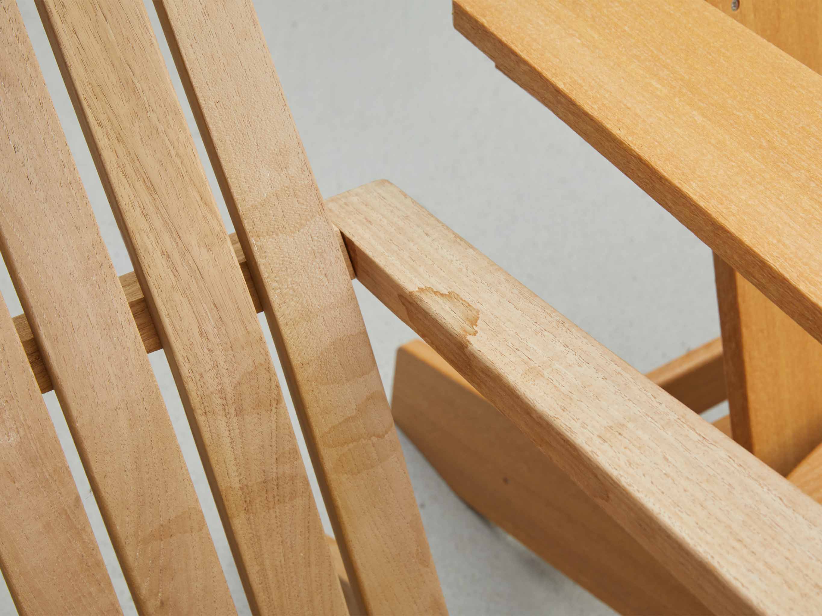 Real wood teak chair next to a Tangentwood Natural Teak Chair Close Up